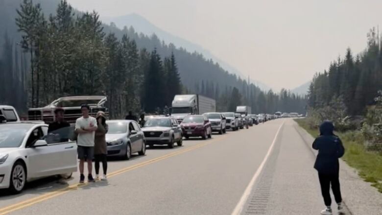 Travellers got out of their cars as traffic came to a standstill Saturday afternoon along the Trans-Canada Highway between Golden and Revelstoke, B.C.