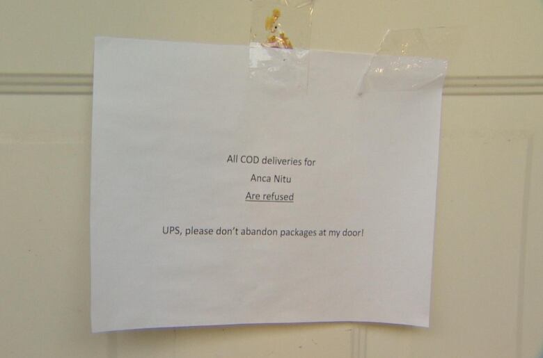 A paper sign is taped to Anca Nitu's front door. It says, 'All deliveries for Anca Nitu are refused. UPS, please don't abandon packages at my door!'