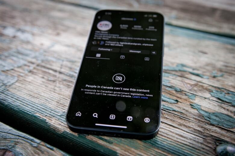 A phone screen shows a page on a social media app that reads, 'People in Canada can't see this content.'