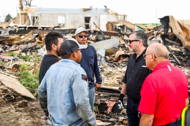 Men survey destruction in Perrytown Texas after a major rain storm.