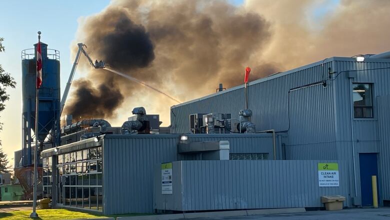 The building that caught fire housed motor oil and other vehicle fluids, firefighters say.