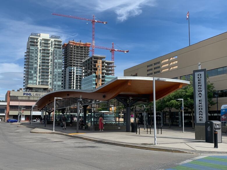 A bus loops with a sign that reads 'Queensway Exchange.'