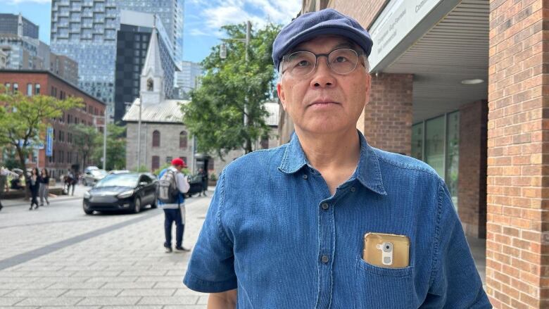 man in denim hat and shirt looking at the camera