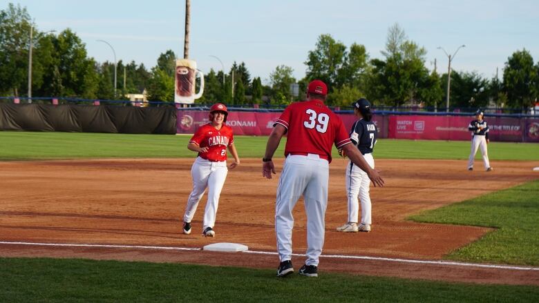 A baseball player runs the bases.