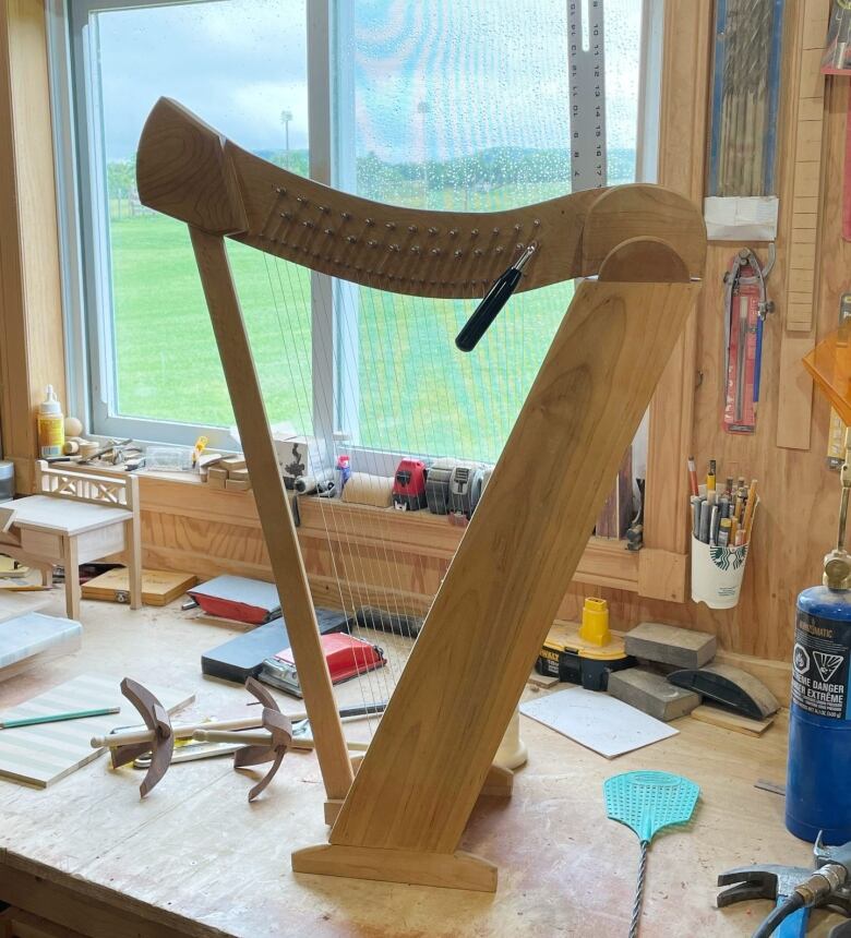 A wooden harp on a workbench