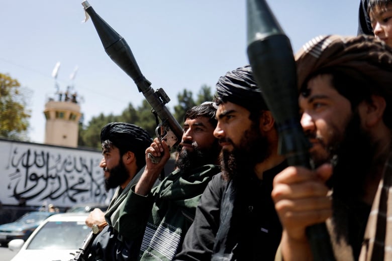 Taliban soldiers celebrate on the second anniversary of the fall of Kabul.