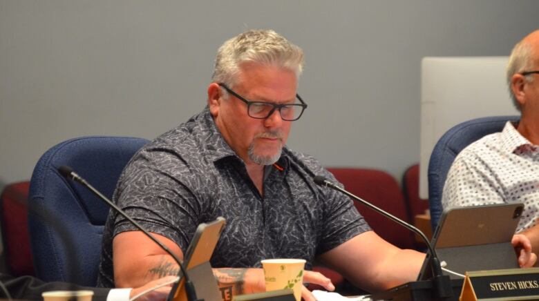 A Fredericton councillor sits in the council chambers.