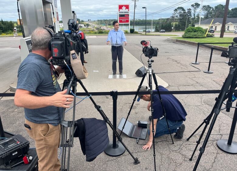 News crews surround Conservative Leader Pierre Poilievre as he holds a news conference at a gas station in Charlottetown.