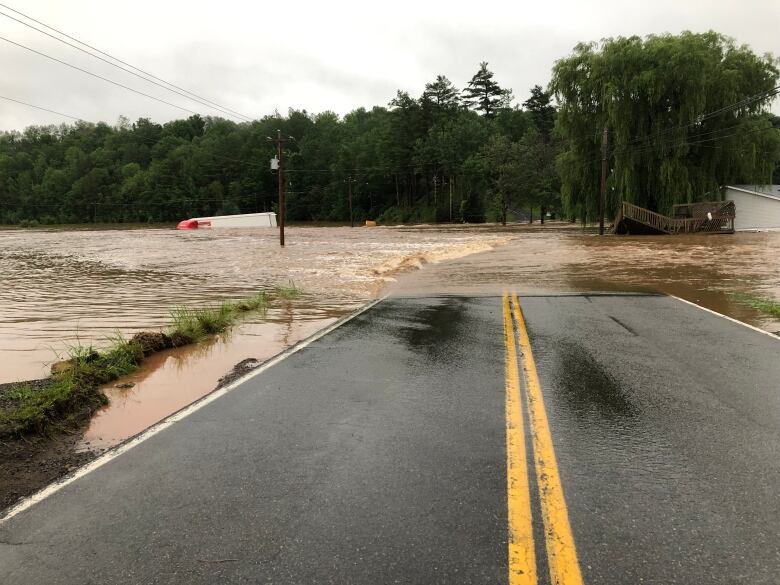 A transport truck is seen partially submerged during flooding in Windsor, N.S.