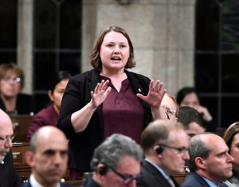 A woman stands and speaks in the House of Commons.