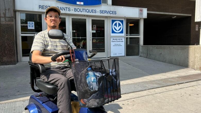 Man in motorized scooter in front of 