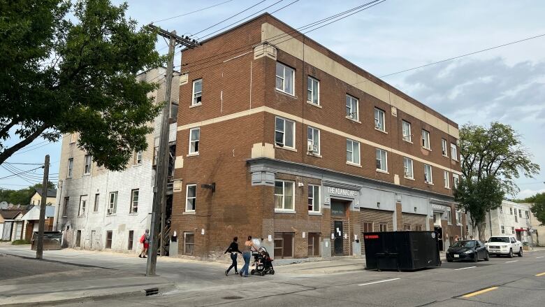 A wide shot of a brown brick building 