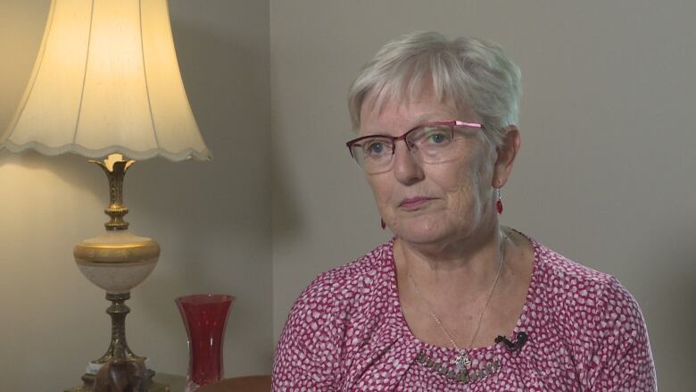 Woman with grey hair in living room