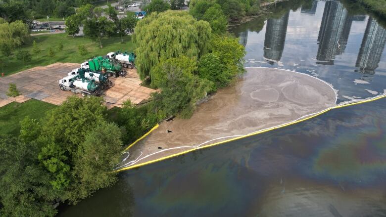 Aerial (drone) images of the run off from the industrialfire in Etobicoke along Mimico Creek now appears to be leaching into the Humber Bay and into Lake Ontario. There is a pond of beige sludge the size of a city pool they're trying to clean up. There is a massive cleanup effort underway. They've closed the Humber Bay Park West Parking lot and boat ramp and brought in a lot of heavy machinery.