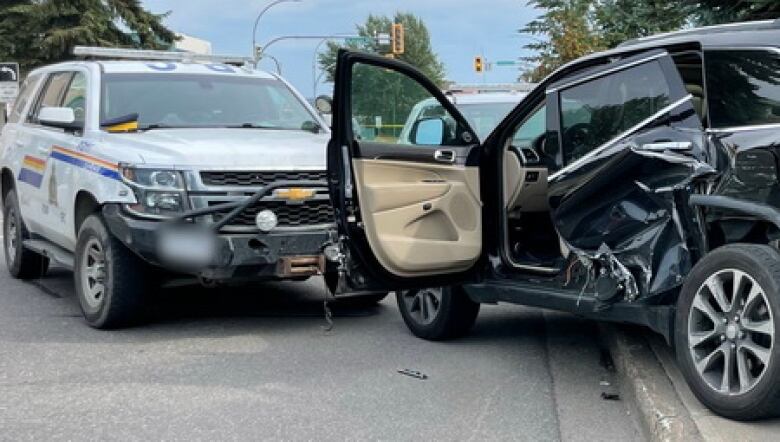 A black car with extensive side door damage and an RCMP cruiser with a mangled front bumper are seen in close proximity.