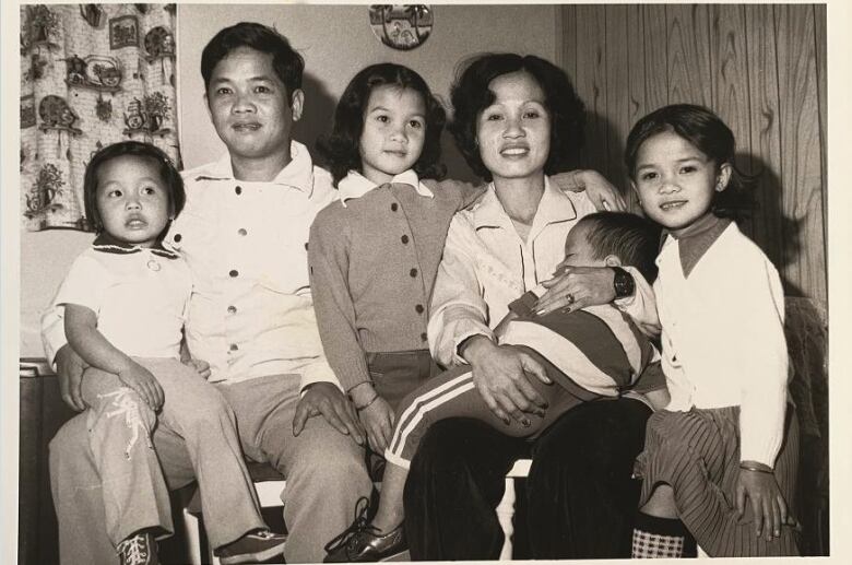 A black-and-white photo of a young family.