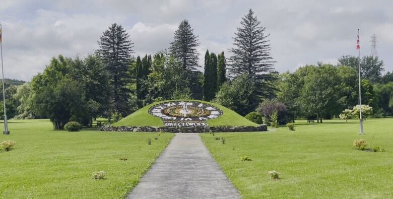 A working floral clock with long pathway leading up to it.