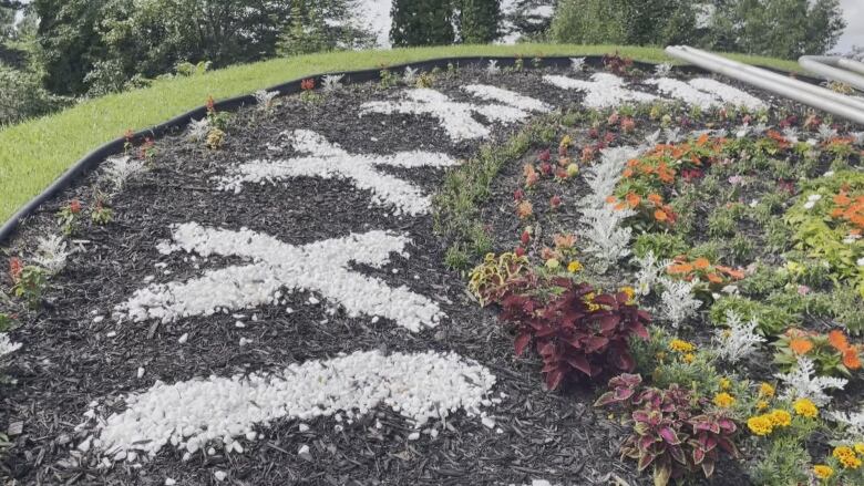 White roman numerals on floral clock.