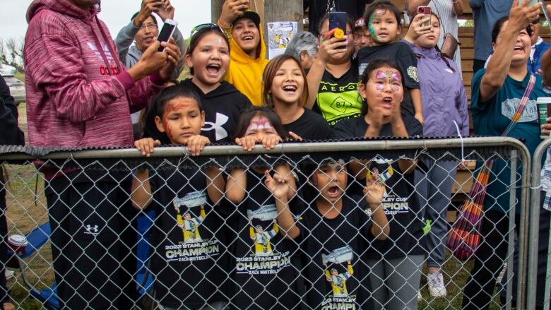 A group of small children wearing Las Vegas Golden Knights t-shirts cheer.