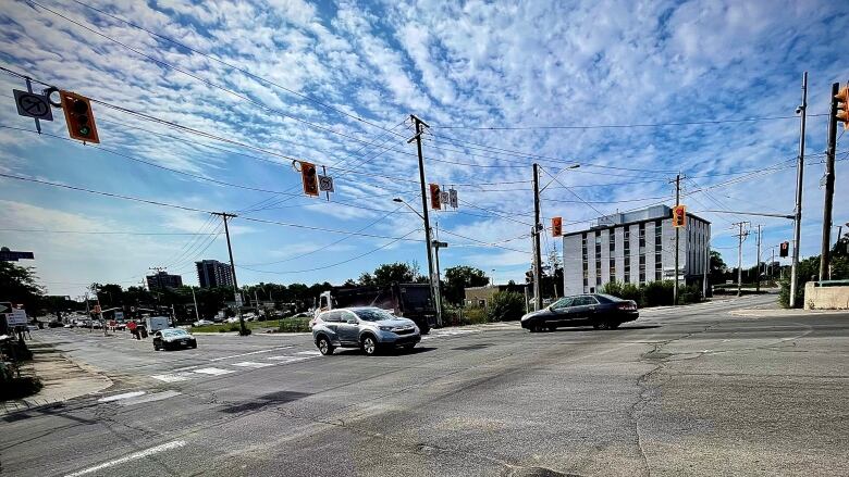 Vehicles drive through the intersection of Bank Street and Riverside Drive.