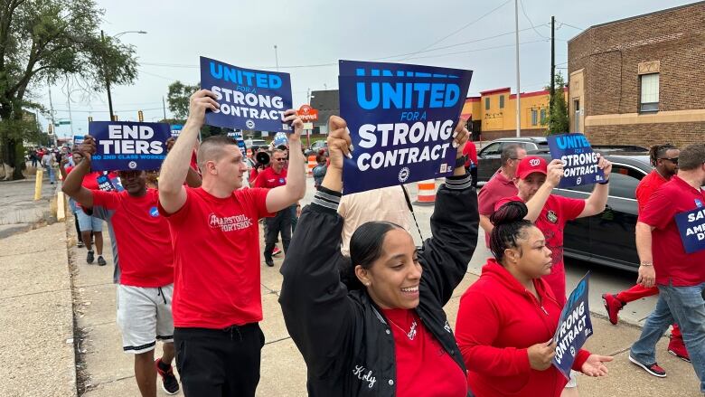 United Auto Workers members march while holding signs at a union rally held near a Stellantis factory Wednesday, Aug. 23, 2023, in Detroit. UAW President Shawn Fain told reporters that bargaining on a new contract is not going well between the UAW and Detroit's three automakers.