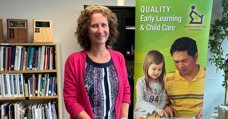 A woman wearing a pink sweater is pictured in front of a banner that reads quality early learning & child care.