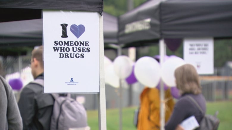 A white sign at a New West Naloxone training event that says 