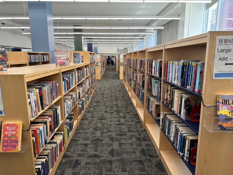 Shelves of books in a library during the day.