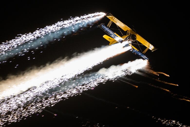 The Skycats pyrotechnics performing at night at an air show in Australia.