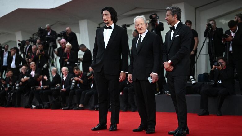 US actor Adam Driver (L), US director Michael Mann and US actor Patrick Dempsey (R) pose on the red carpet of the movie 