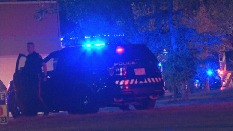 A police officer exits a vehicle. 