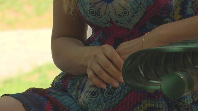 A woman's hands folded together anxiously.