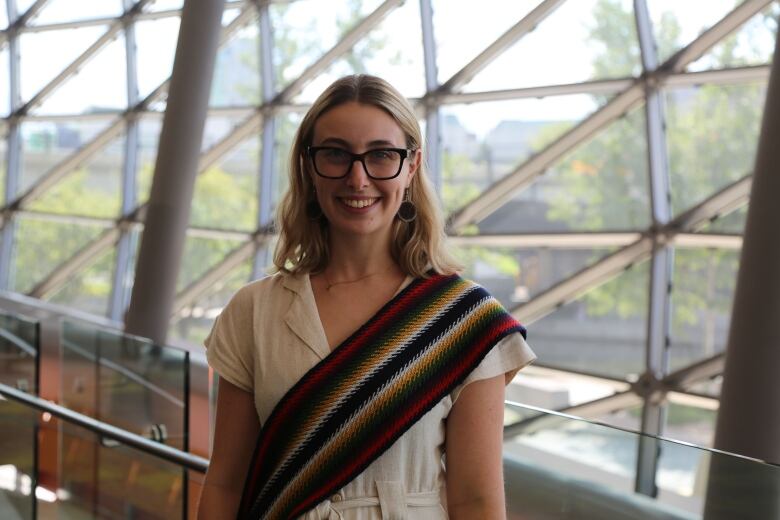 A young woman wearing dark glasses.