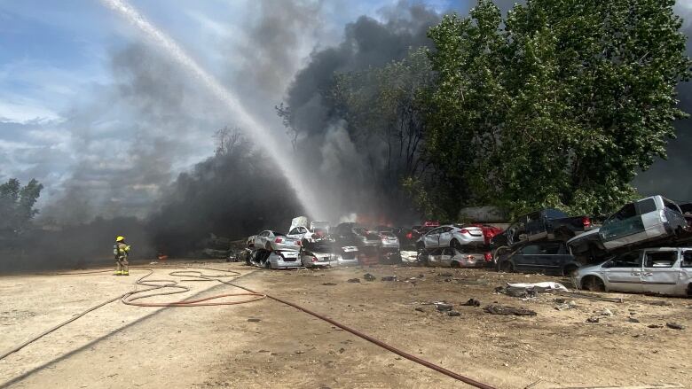 Crews work to put out a fire at a Chatham scrap yard on Sept. 6, 2023.