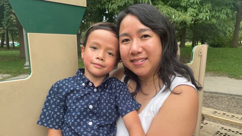 A mother and her son at a park. 