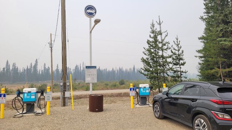 A car sits at a charging station.