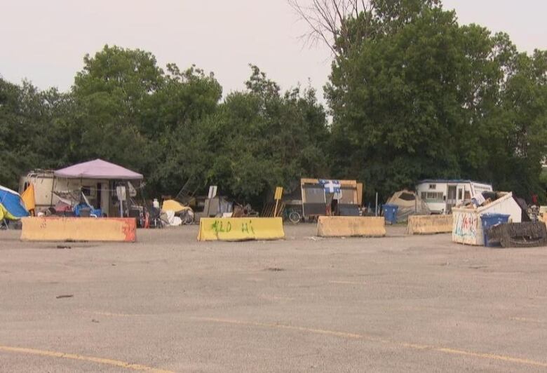 Several tents in a parking lot.