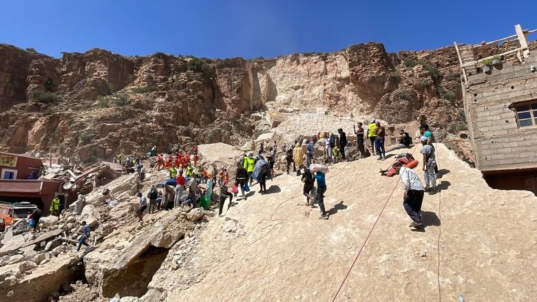 Residents of Imi N'Tala told CBC 100 people, or half the village, perished in the earthquake. A giant slab of the mountain above crashed down onto the homes below, burying many people.