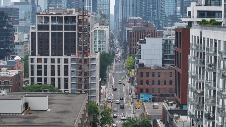 An aerial shot of a densely developed city skyline filled with tall buildings.