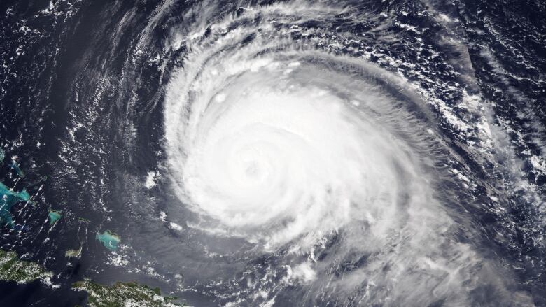 A satellite image shows swirling clouds.