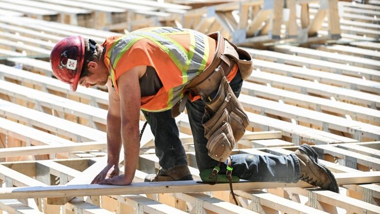 A worker builds a home in Montreal.