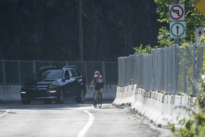 cyclist near a car