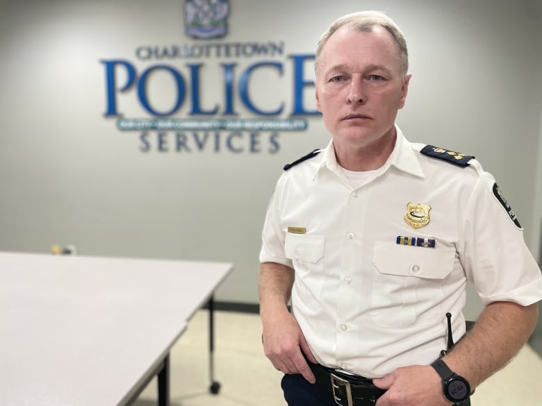 Charlottetown Police Chief Brad McConnell in uniform stands in a room at the police station. 