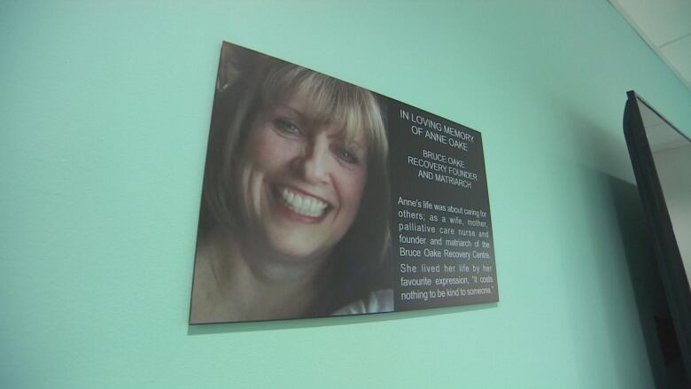 A plaque on a while commemorates the life of a woman who helped found an addictions recovery centre.