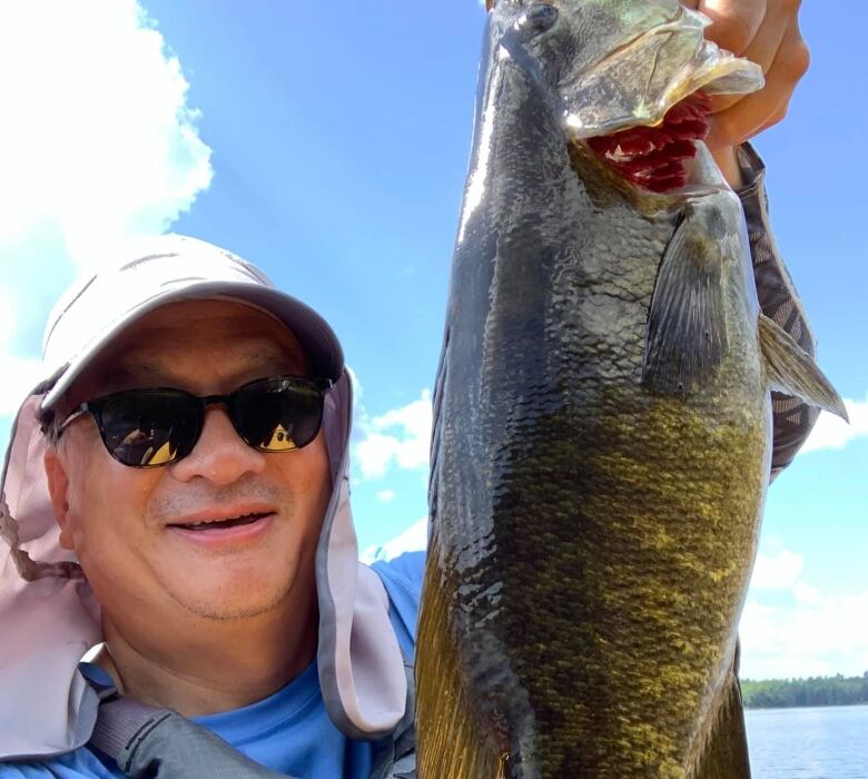 Brad Lee holds a fish. 