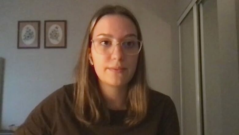 Woman with light brown hair and glasses participating in an online focus group. 