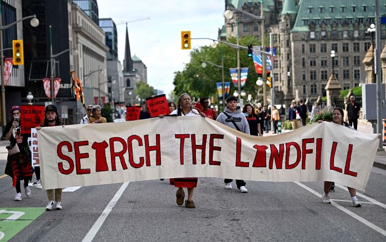 Marchers hold a banner that says 