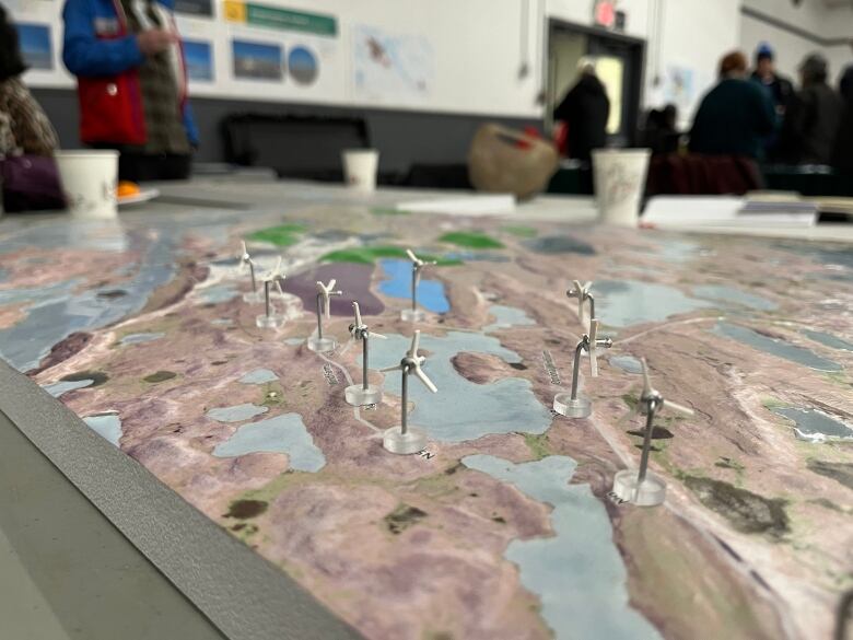 A diorama of windmills on tundra.