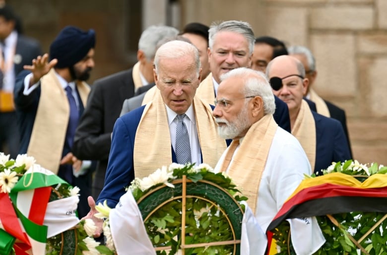 U.S. President Joe Biden, center, Indian Prime Minister Narendra Modi, and other G20 leaders arrive to pay their tributes at the Rajghat, a Mahatma Gandhi memorial, in New Delhi, India, Sunday, Sept. 10, 2023.