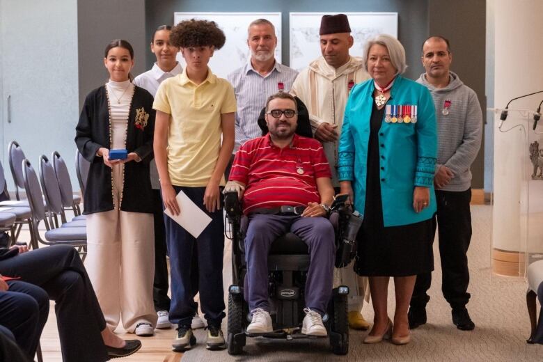 Quebec mosque shooting survivors who were honoured with medals and their kids posing with Mary Simon 